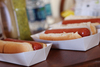A Picture of product 251-142 SCT Hot Dog Food Trays. 7 X 2.75 X 1.5 in. White. 250/sleeve, 4 sleeves/case.
